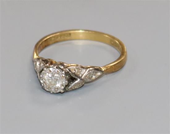 A Bravingtons 18ct gold and platinum, illusion set single stone diamond ring with diamond set shoulders, size L.